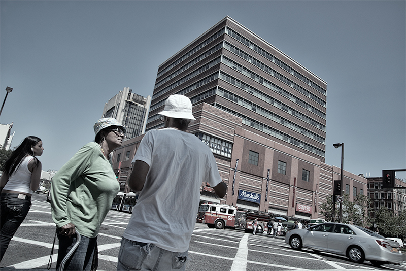 Two people in conversation at intersection.