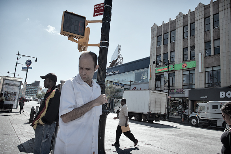 Man in white shirt at intersection.