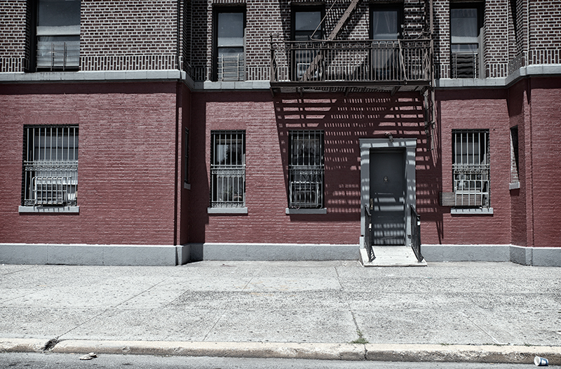 Facade of painted red brick building.