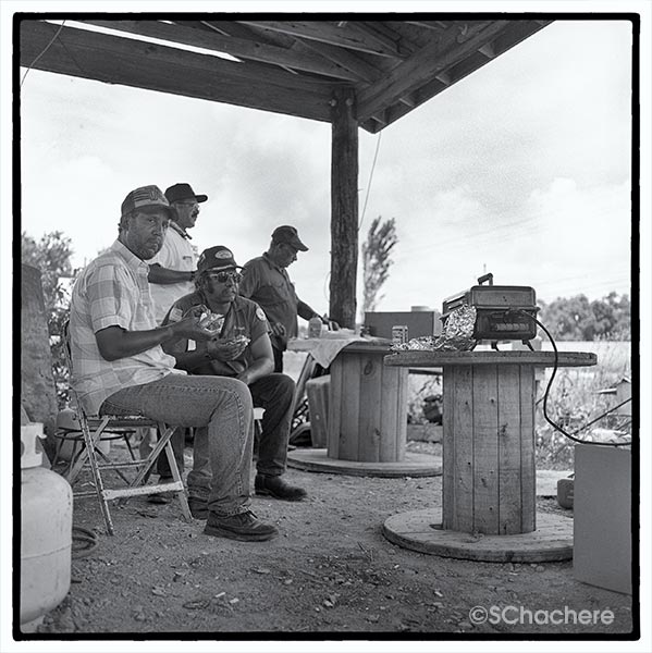 Men sitting under overhang