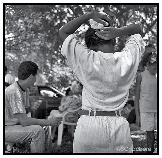 Girl fixing hair, at picnic.