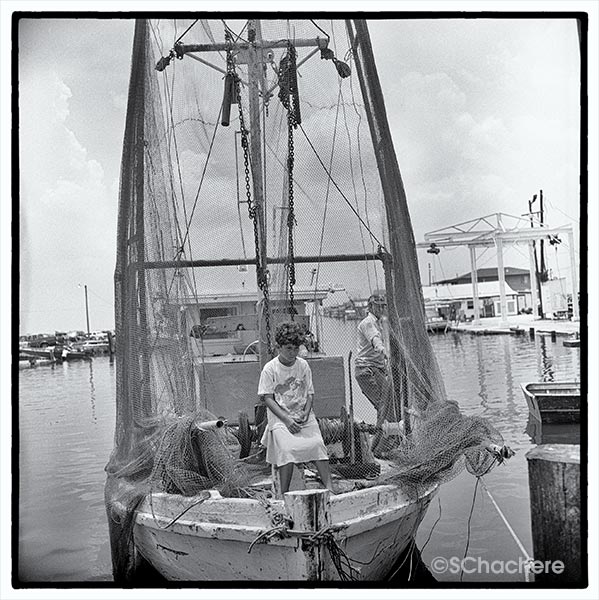 Girl sitting on boat at marina