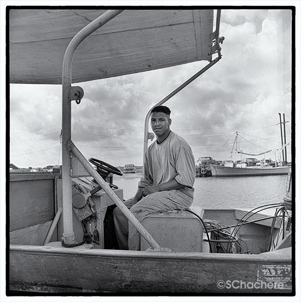 Man on boat at marina.