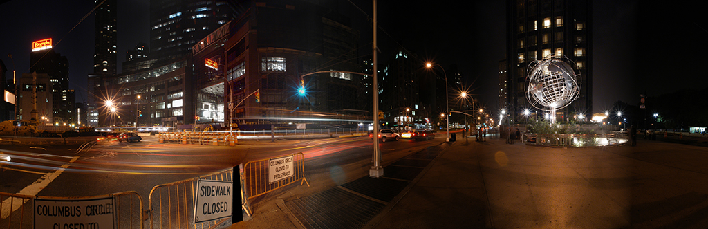 Panoramic view of Columbus Circle and empty New York streets at night