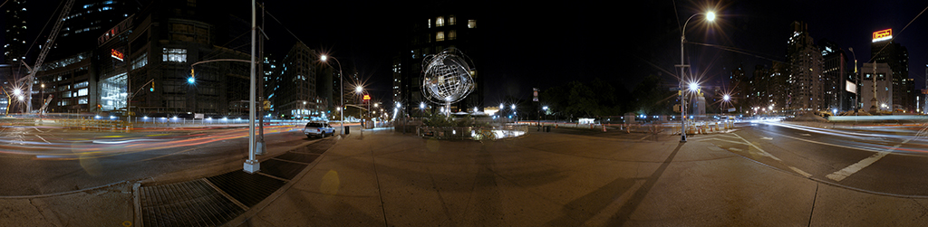Panoramic view of Columbus Circle and empty New York streets at night