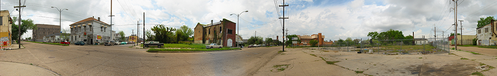 360 degree view of street intersection with old buildings and broken pavement