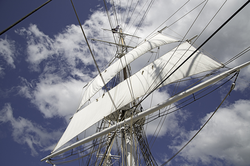 Sails against clouds and blue sky